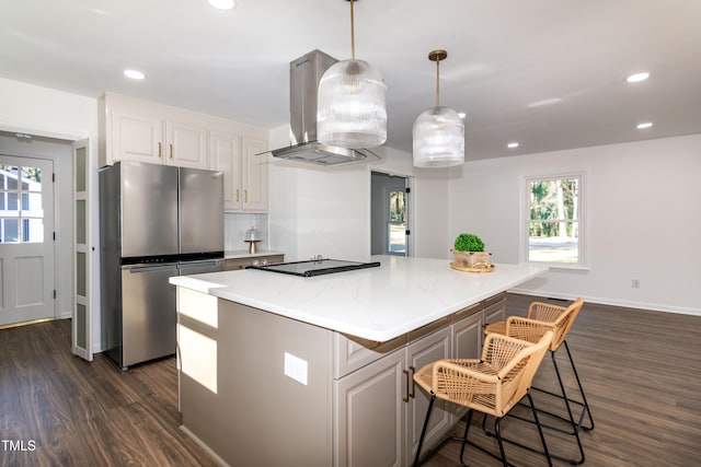 5920 Holly Dr, Raleigh, NC 27616 - kitchen with freestanding refrigerator, ventilation hood, black electric stovetop, dark wood finished floors, and white cabinets