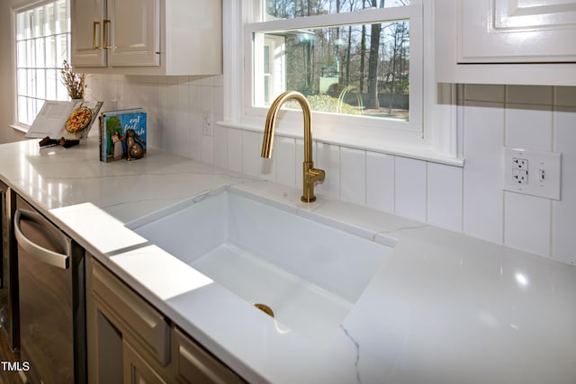 5920 Holly Dr, Raleigh, NC 27616 - kitchen featuring dishwasher, decorative backsplash, light stone countertops, and white cabinetry