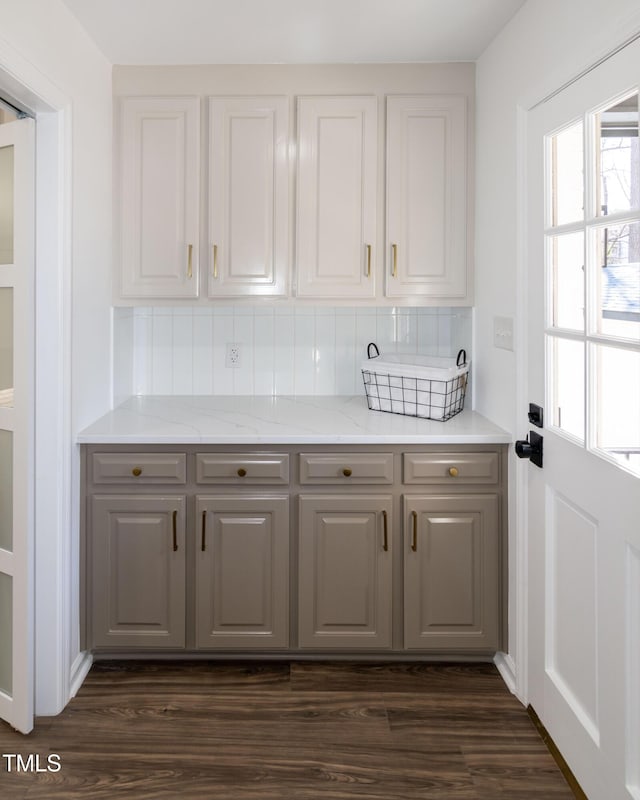 5920 Holly Dr, Raleigh, NC 27616 - kitchen with gray cabinets, backsplash, dark wood finished floors, light stone counters, and white cabinetry