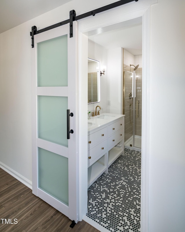 5920 Holly Dr, Raleigh, NC 27616 - full bathroom with vanity, a shower stall, and wood finished floors