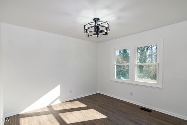 5920 Holly Dr, Raleigh, NC 27616 - unfurnished room featuring a chandelier and dark wood-style floors