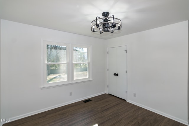 5920 Holly Dr, Raleigh, NC 27616 - unfurnished room with a chandelier and dark wood-type flooring