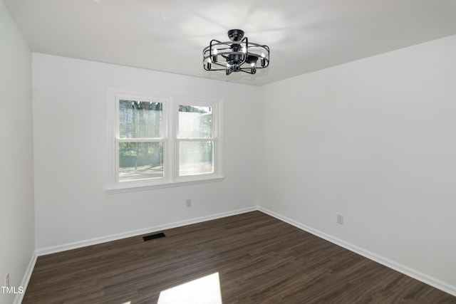 5920 Holly Dr, Raleigh, NC 27616 - unfurnished room featuring a chandelier and dark wood-style flooring
