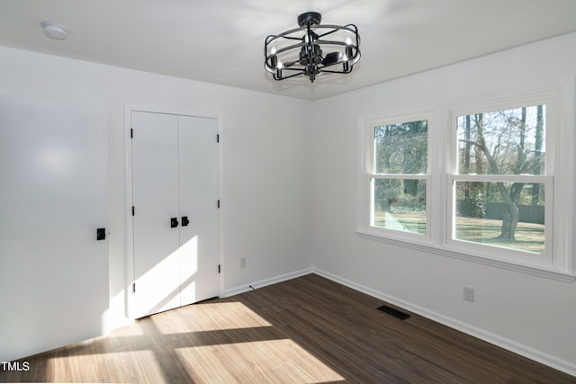 5920 Holly Dr, Raleigh, NC 27616 - unfurnished dining area with a chandelier, plenty of natural light, and dark wood finished floors