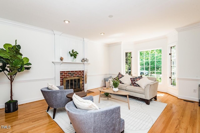 2054 Carriage Way, Chapel Hill, NC 27517 - living room featuring crown molding, light wood-style flooring, a brick fireplace, and recessed lighting