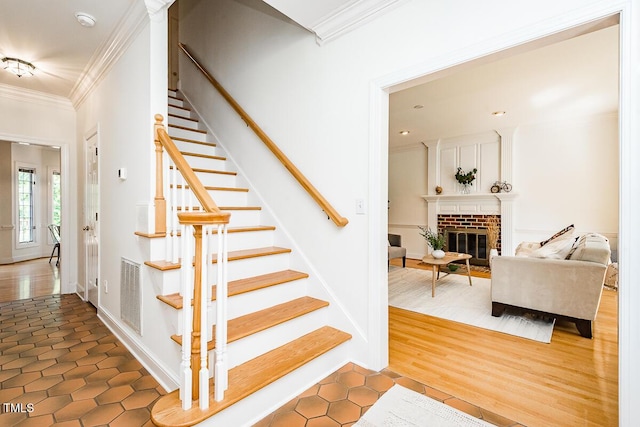 2054 Carriage Way, Chapel Hill, NC 27517 - stairs featuring ornamental molding, a brick fireplace, and tile patterned floors