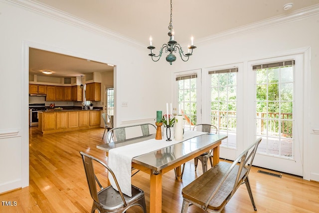 2054 Carriage Way, Chapel Hill, NC 27517 - dining space with crown molding, plenty of natural light, a chandelier, and light wood-type flooring