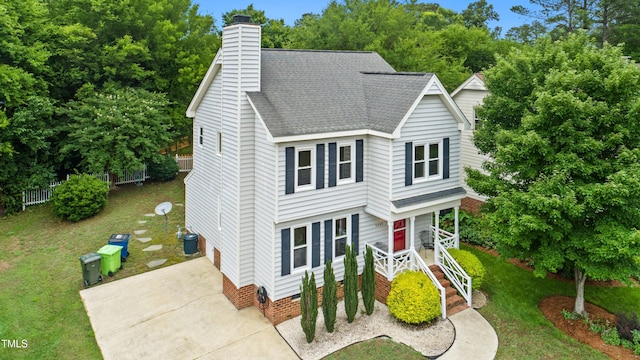 3405 E Jameson Rd, Raleigh, NC 27604 - view of front of house featuring a shingled roof, concrete driveway, a front yard, and a chimney