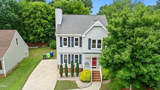 3405 E Jameson Rd, Raleigh, NC 27604 - view of front of house with a front lawn, a chimney, roof with shingles, and a porch