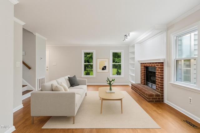 3405 E Jameson Rd, Raleigh, NC 27604 - living area featuring wood finished floors, crown molding, stairway, a fireplace, and built in features