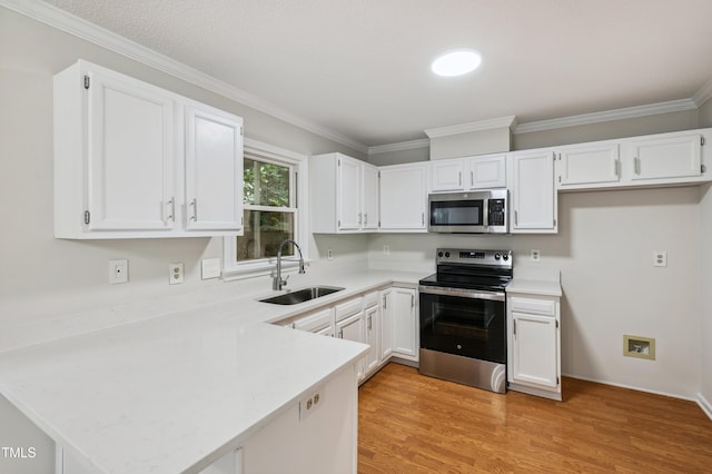3405 E Jameson Rd, Raleigh, NC 27604 - kitchen featuring appliances with stainless steel finishes, a peninsula, light countertops, white cabinets, and light wood-style flooring