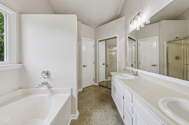 3405 E Jameson Rd, Raleigh, NC 27604 - bathroom featuring a garden tub, double vanity, a closet, and healthy amount of natural light