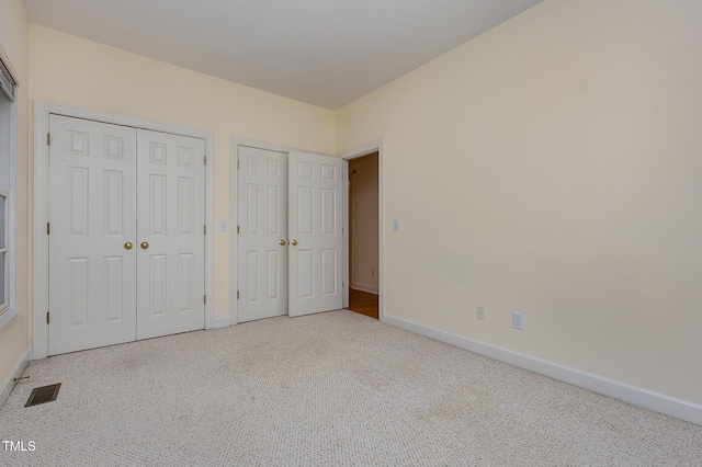 23 Lauren Ct, Pittsboro, NC 27312 - unfurnished bedroom featuring two closets and carpet floors