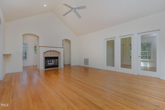 23 Lauren Ct, Pittsboro, NC 27312 - unfurnished living room featuring high vaulted ceiling, a ceiling fan, light wood-type flooring, and a fireplace