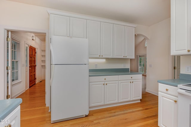 23 Lauren Ct, Pittsboro, NC 27312 - kitchen with freestanding refrigerator, arched walkways, light wood-style floors, and stove