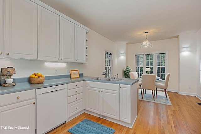 23 Lauren Ct, Pittsboro, NC 27312 - kitchen featuring white dishwasher, a peninsula, white cabinets, and light wood-style flooring