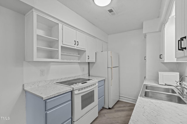 624 Pine Ridge Pl, Raleigh, NC 27609 - kitchen with white appliances, open shelves, white cabinetry, and light countertops