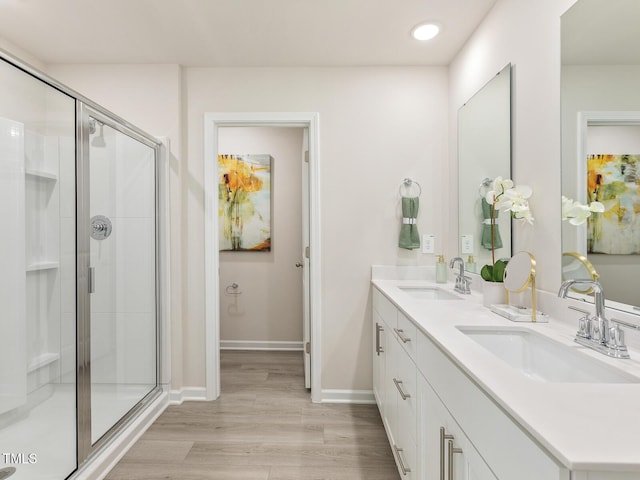 2295 Cherry Creek Rd, Haw River, NC 27258 - full bathroom with double vanity, a stall shower, wood finished floors, and recessed lighting