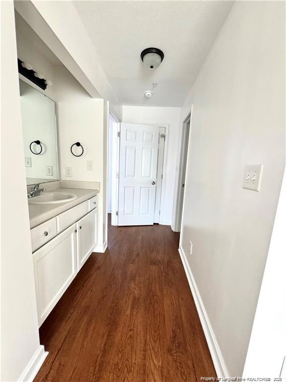 208 Waterdown Dr Unit 10, Fayetteville, NC 28314 - hallway with a sink and dark wood-style flooring