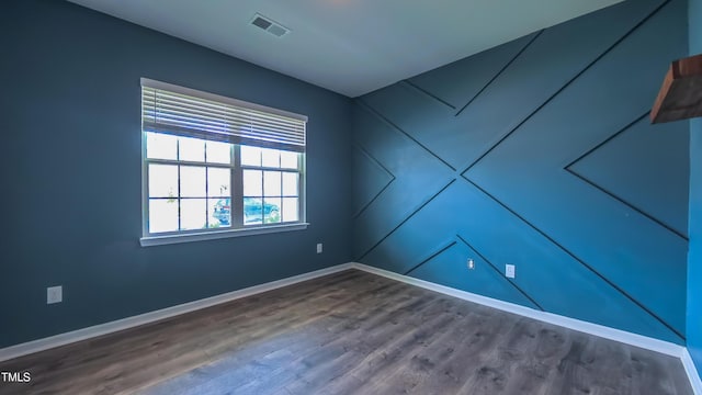 67 Red Cedar Way, Fuquay Varina, NC 27526 - spare room with baseboards and dark wood-type flooring