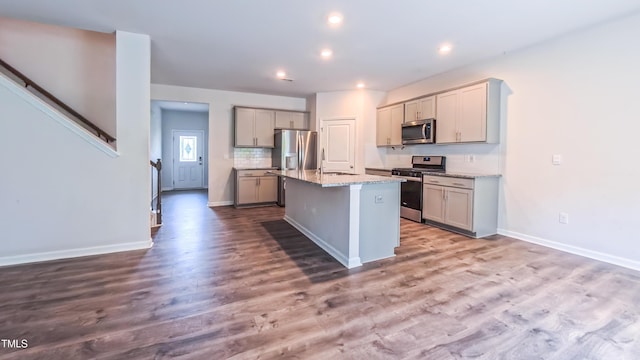 67 Red Cedar Way, Fuquay Varina, NC 27526 - kitchen featuring stainless steel appliances, gray cabinetry, wood finished floors, recessed lighting, and an island with sink