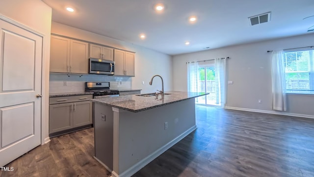 67 Red Cedar Way, Fuquay Varina, NC 27526 - kitchen with stainless steel appliances, gray cabinetry, an island with sink, dark wood-style floors, and recessed lighting