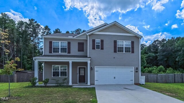 67 Red Cedar Way, Fuquay Varina, NC 27526 - traditional-style house with an attached garage, concrete driveway, and covered porch
