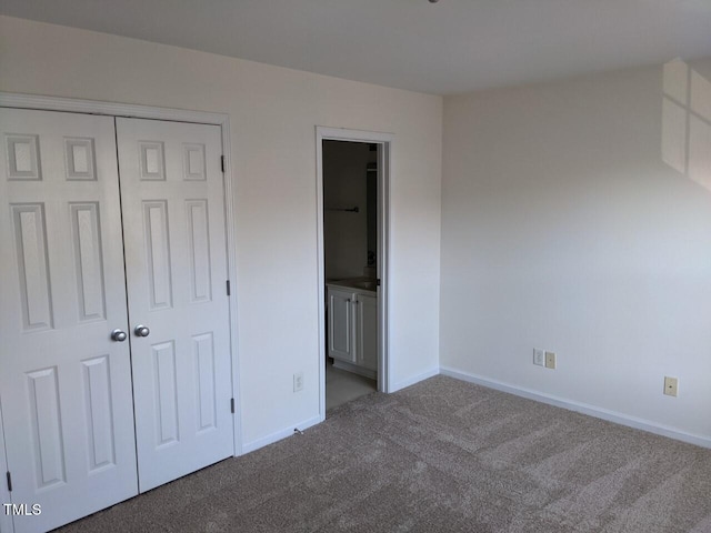 8253 City Loft Ct, Raleigh, NC 27613 - unfurnished bedroom featuring carpet flooring, a closet, and connected bathroom
