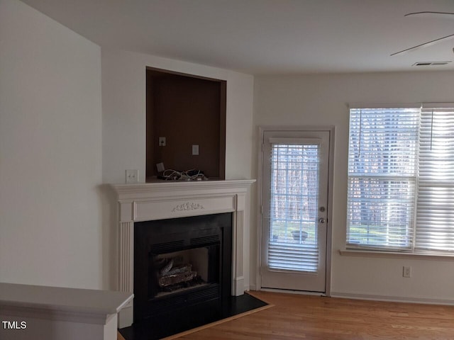 8253 City Loft Ct, Raleigh, NC 27613 - living area with a fireplace with flush hearth and wood finished floors