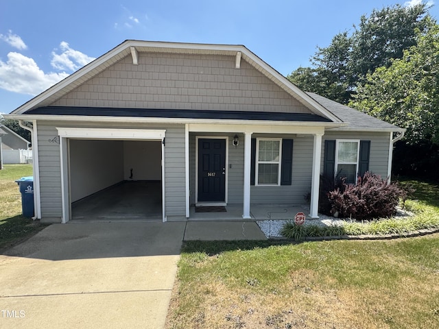 1617 Friendly Rd, Dunn, NC 28334 - view of front of property with driveway, an attached garage, covered porch, and a front lawn