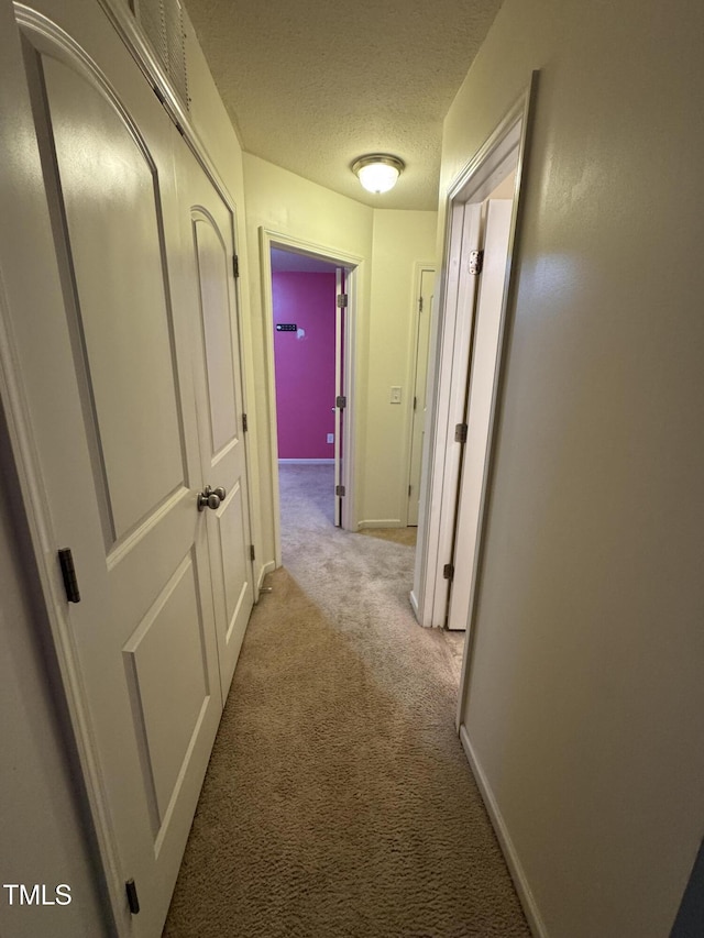 1617 Friendly Rd, Dunn, NC 28334 - hallway featuring carpet flooring and a textured ceiling