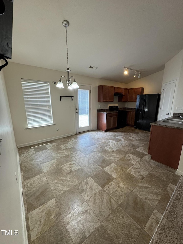 1617 Friendly Rd, Dunn, NC 28334 - kitchen with black refrigerator with ice dispenser, dark countertops, a chandelier, and hanging light fixtures