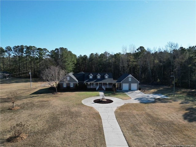 11282 NC Highway 41 N, Lumberton, NC 28358 - view of front of property featuring a front lawn, a wooded view, curved driveway, and an attached garage