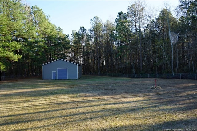 11282 NC Highway 41 N, Lumberton, NC 28358 - view of yard featuring a garage, an outbuilding, a pole building, and a forest view