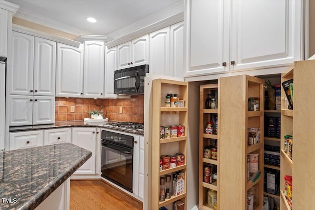 12329 Whartons Way, Raleigh, NC 27613 - kitchen featuring black appliances, white cabinets, dark stone countertops, light wood-style floors, and recessed lighting