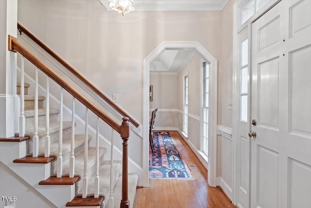 12329 Whartons Way, Raleigh, NC 27613 - entrance foyer with arched walkways, ornamental molding, light wood-style flooring, and stairs