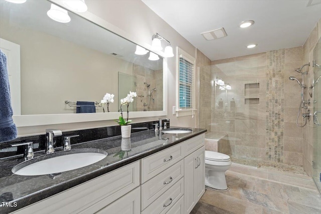 12329 Whartons Way, Raleigh, NC 27613 - full bath with a tile shower, double vanity, recessed lighting, and stone finish floors