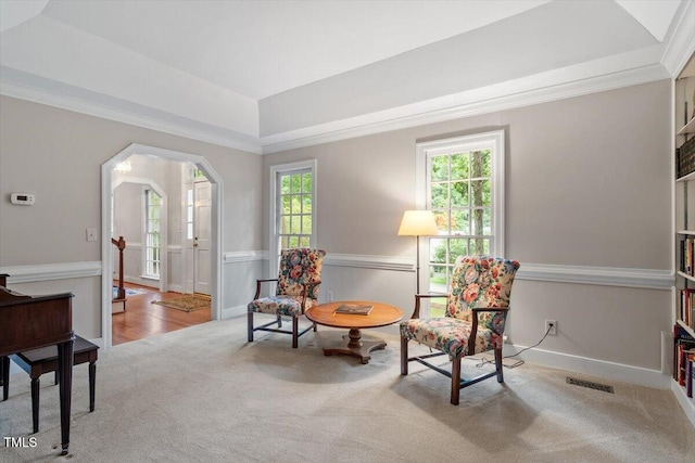 12329 Whartons Way, Raleigh, NC 27613 - living area with carpet floors, a tray ceiling, arched walkways, crown molding, and a wainscoted wall