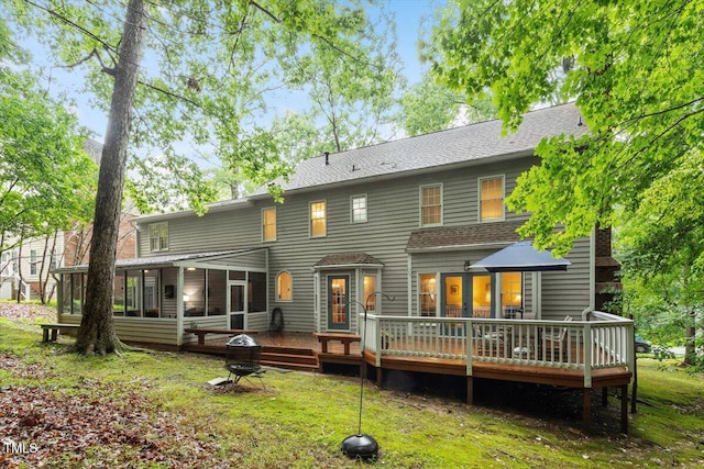 12329 Whartons Way, Raleigh, NC 27613 - back of property with a sunroom, a wooden deck, a shingled roof, and a lawn