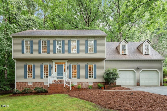 12329 Whartons Way, Raleigh, NC 27613 - colonial home with driveway, an attached garage, a front lawn, roof with shingles, and crawl space