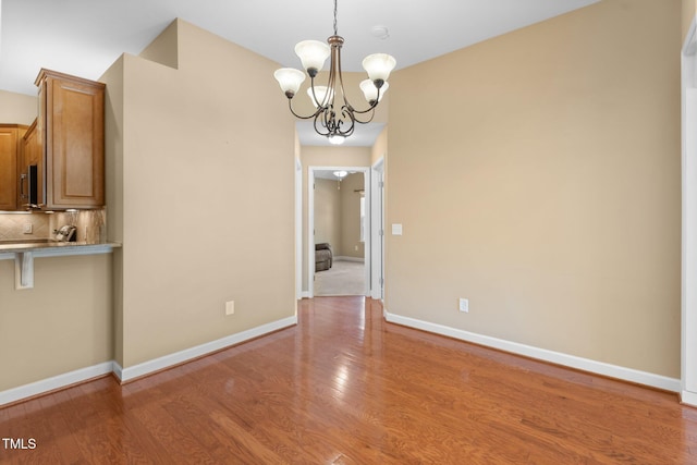 336 Faith Dr, Gibsonville, NC 27249 - unfurnished dining area featuring a chandelier and light wood-type flooring
