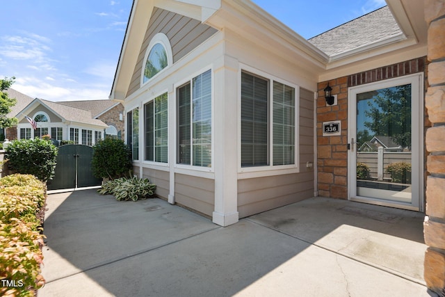 336 Faith Dr, Gibsonville, NC 27249 - doorway to property featuring a gate, roof with shingles, and stone siding