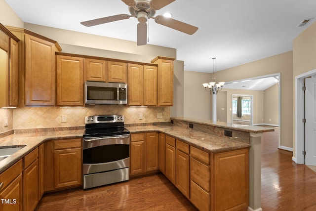 336 Faith Dr, Gibsonville, NC 27249 - kitchen featuring appliances with stainless steel finishes, a peninsula, decorative backsplash, dark wood-style floors, and ceiling fan
