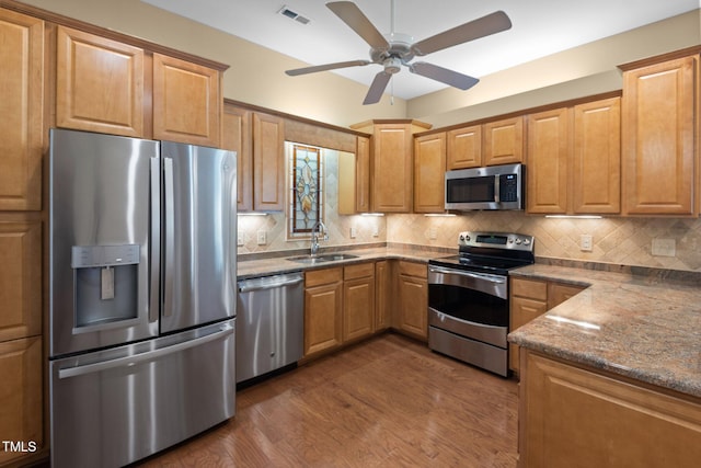 336 Faith Dr, Gibsonville, NC 27249 - kitchen with stainless steel appliances, a ceiling fan, dark wood-type flooring, and backsplash