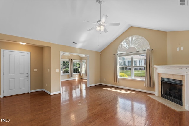 336 Faith Dr, Gibsonville, NC 27249 - unfurnished living room with ceiling fan, a tiled fireplace, lofted ceiling, and wood finished floors