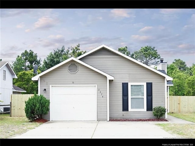3374 Legion Rd, Hope Mills, NC 28348 - view of front of home featuring a garage, driveway, and a chimney