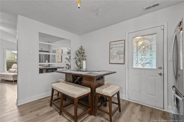 3374 Legion Rd, Hope Mills, NC 28348 - dining space with light wood-style floors and a textured ceiling