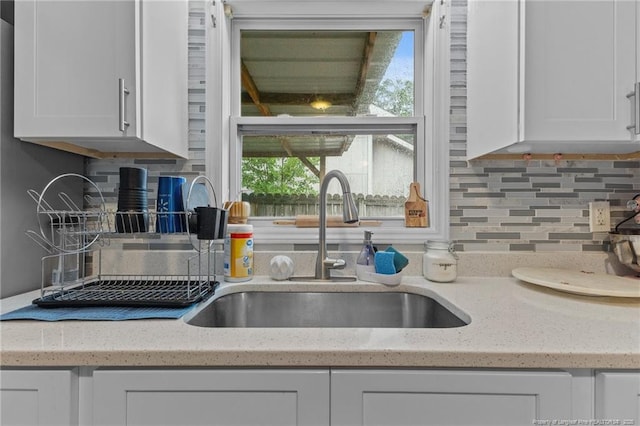3374 Legion Rd, Hope Mills, NC 28348 - kitchen featuring white cabinets, plenty of natural light, and tasteful backsplash
