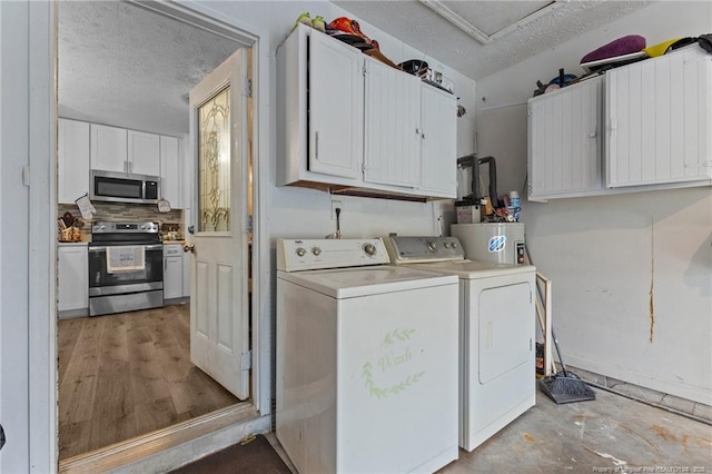 3374 Legion Rd, Hope Mills, NC 28348 - washroom with washer and clothes dryer, a textured ceiling, and cabinet space