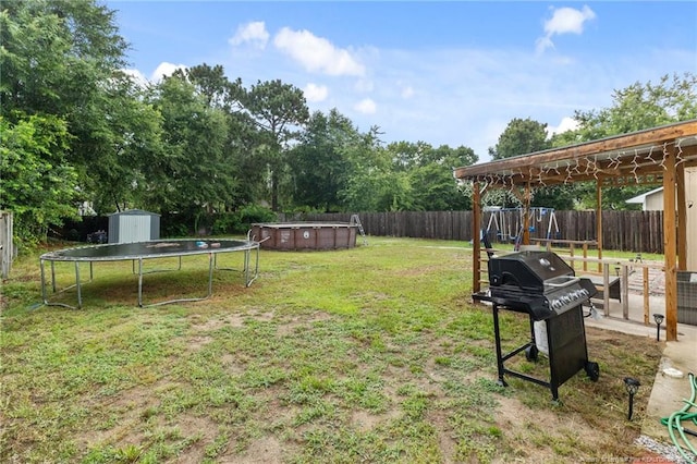 3374 Legion Rd, Hope Mills, NC 28348 - fenced backyard with a playground, a storage shed, and a trampoline